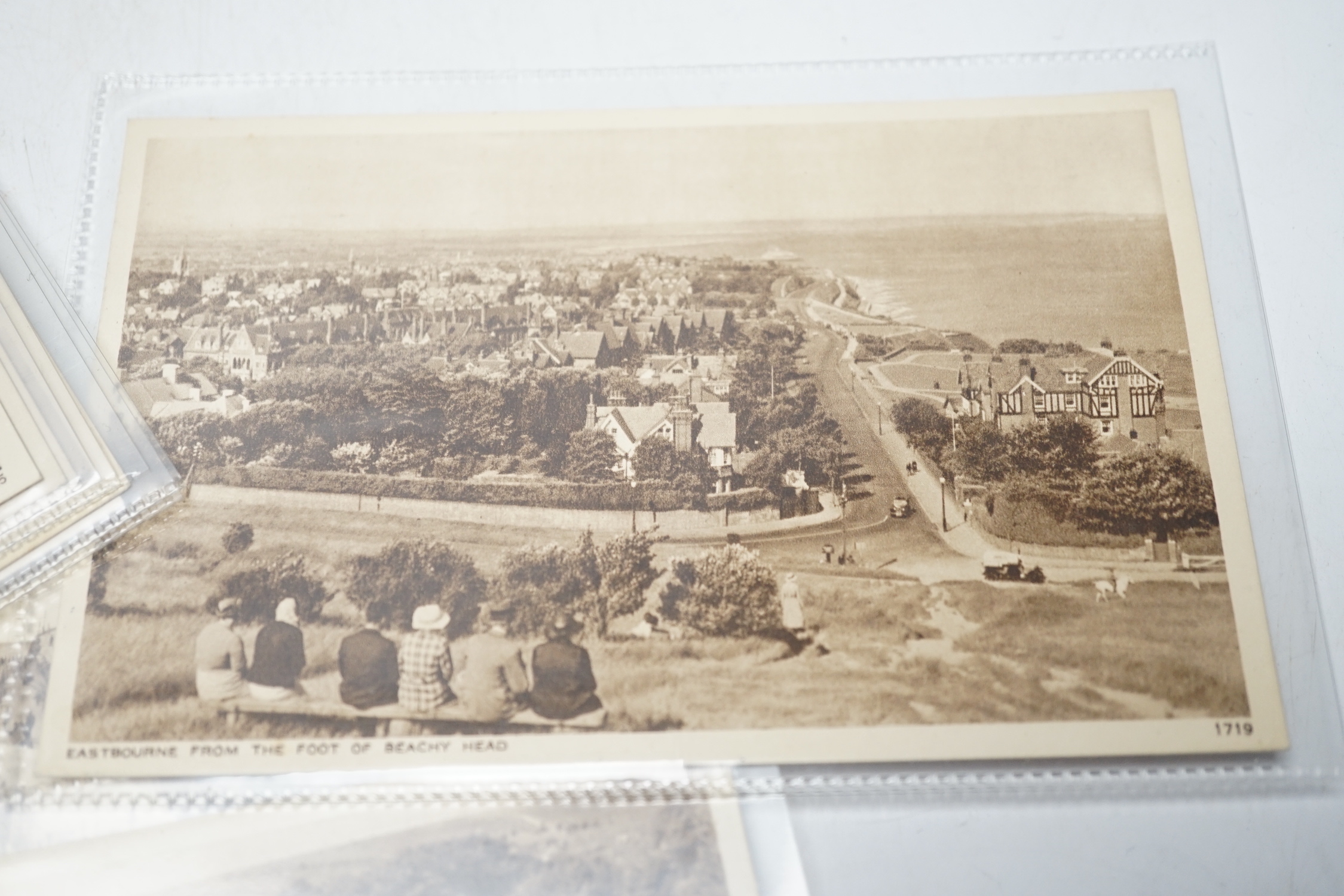 A large quantity of early to mid 20th century postcards of Eastbourne and the surrounding area, all in individual protective sleeves (in two boxes)